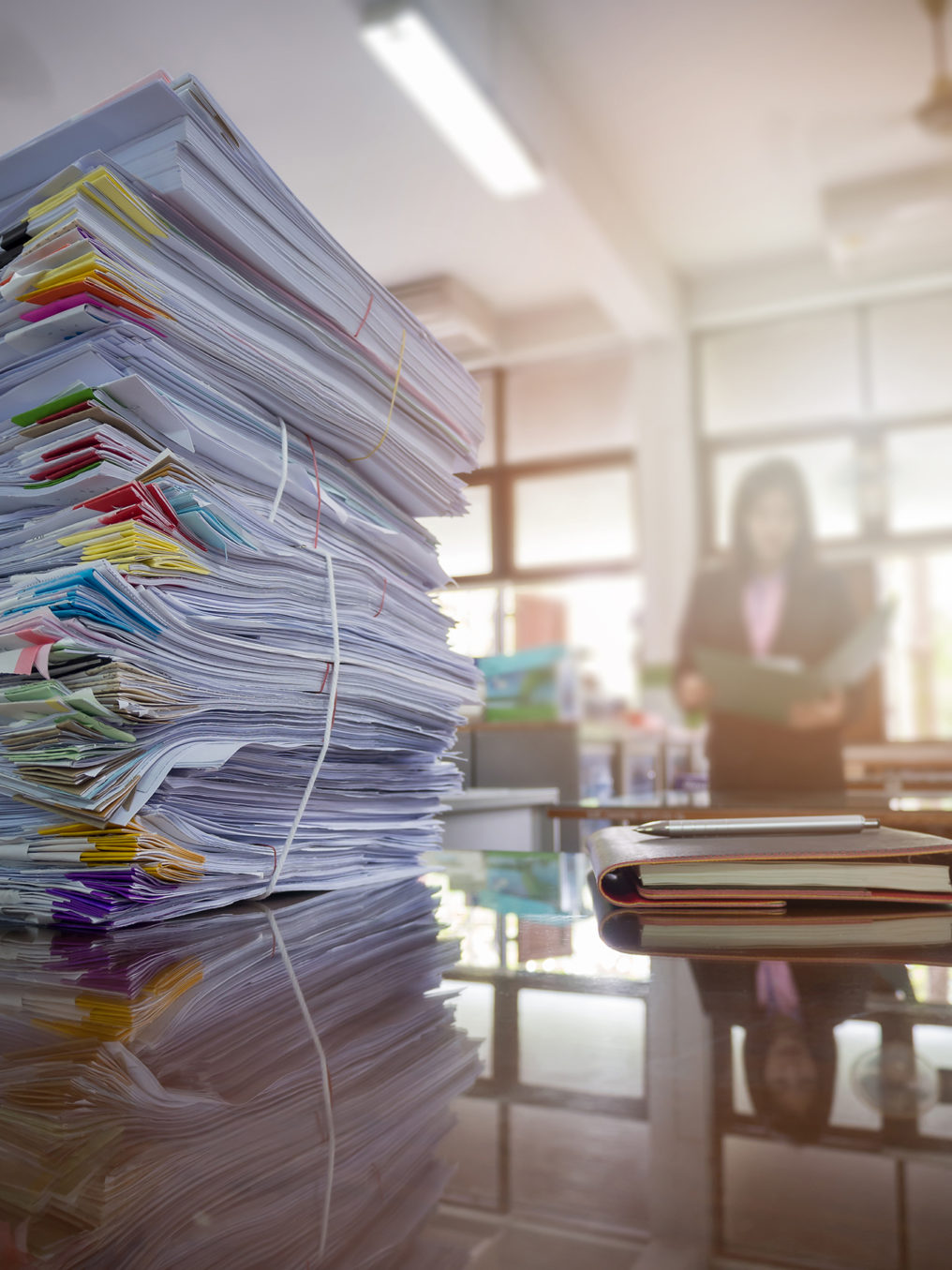 Pile Of Unfinished Documents On Office Desk