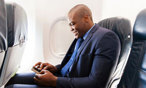 man on plane with mobile device, Xerox, Connect Key, Corporate Business Systems, Madison, WI, IL, Xerox, Canon, HP, Dealer, Reseller, Wisconsin, Illinois